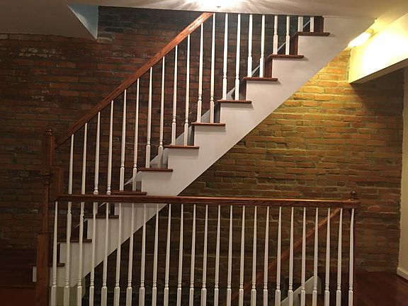 Oak staircase with exposed brick