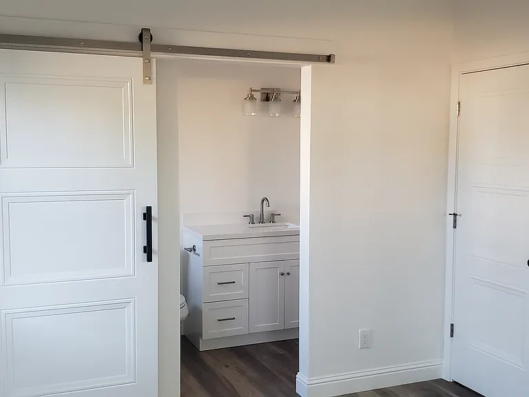 Master bedroom door closed. A sliding barn door provides easy close or open from bedroom area.