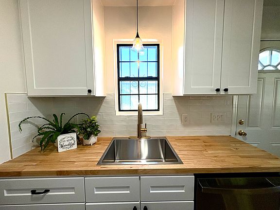 lovely butcher block countertops and natural light from window over the sink.