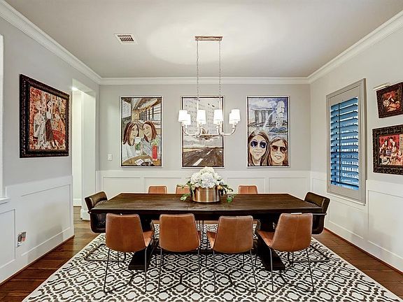 Entertain in uncrowded comfort in this spacious dining room. Notice the elegant wainscot that wraps around the room and the sleek chandelier that hangs over the dining room table.