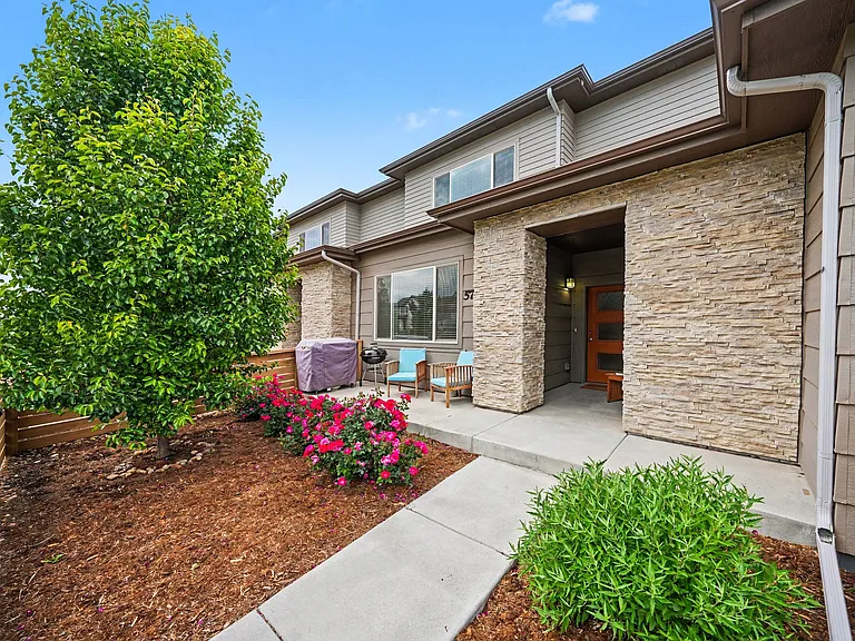 Fenced in front yard with covered patio