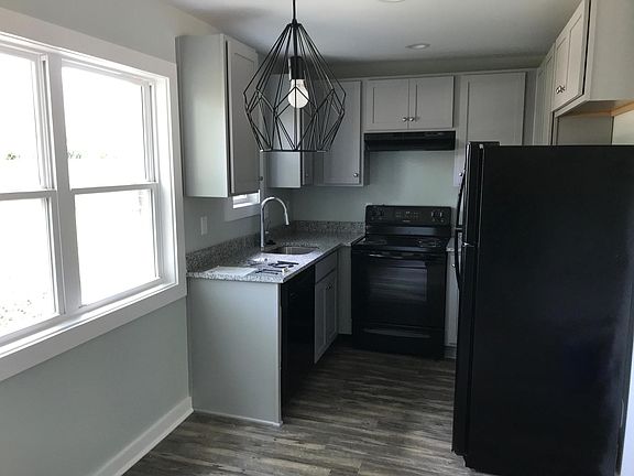 Recently updated kitchen with fridge, dishwasher, range and hood vent.