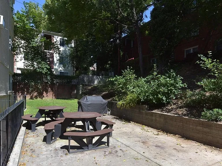 Back patio with grill and tables, shared by building residents