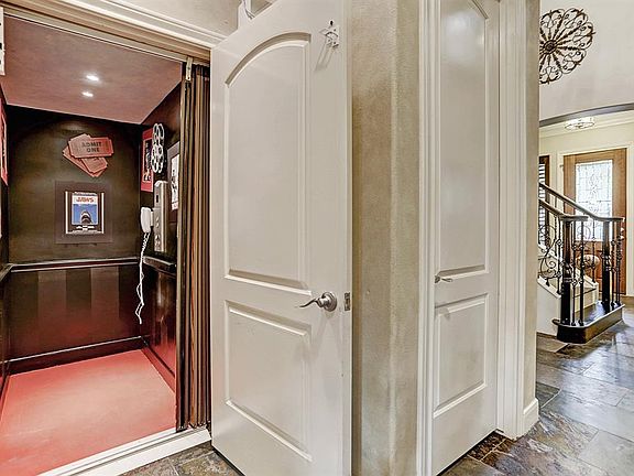 Oversize elevator located near staircase and entry.