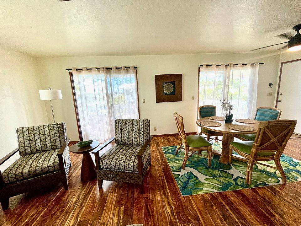 This photo shows half of the living space towards the lanai and dining area.