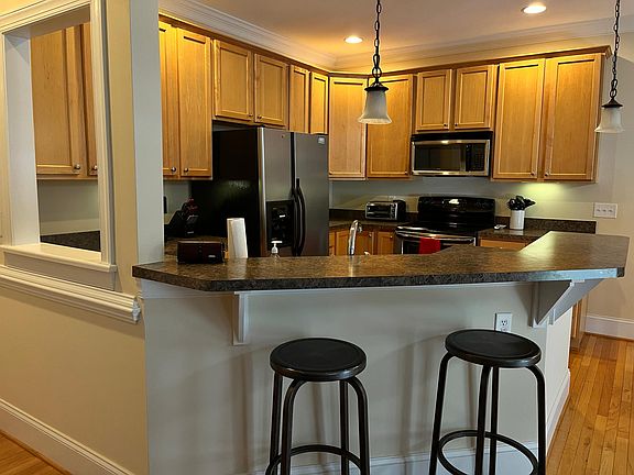 View of Kitchen area with two counter bar stools