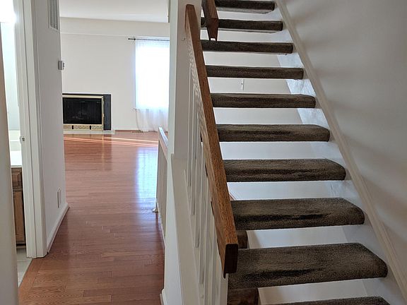 Hallway and stairs. Powder room is on the left