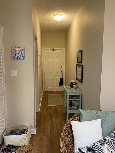 Looking from living area to entry door. Bedroom door is on the left.