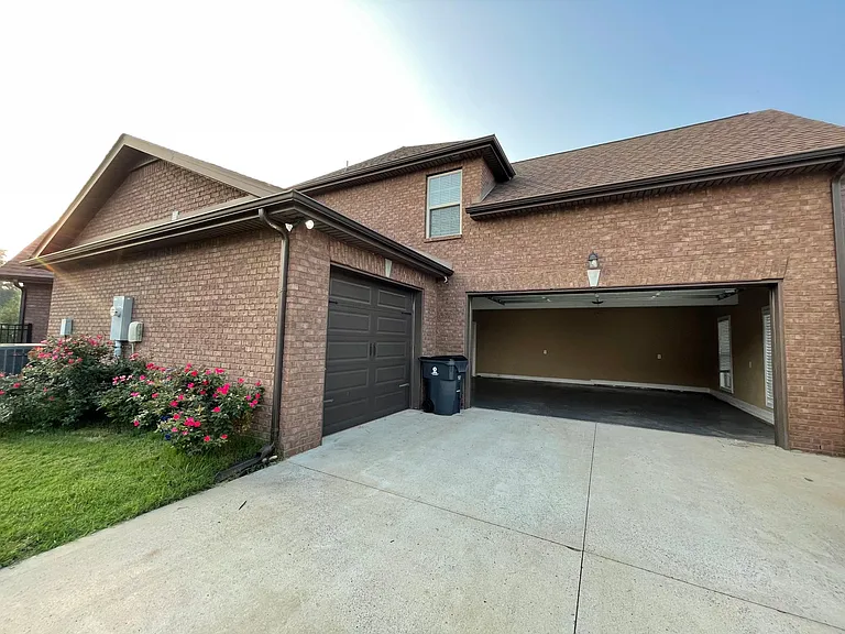 Spacious THREE car garage with durable painted floors, finished interior, and plenty of light from windows.