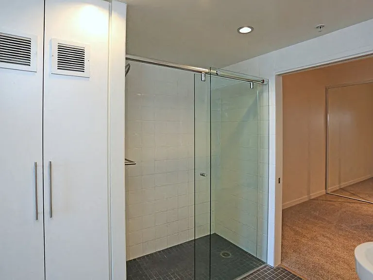 Bathroom and carpeted bedroom at 12th Street Lofts in National City, California.