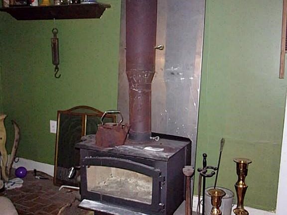 Living-room has antique wood burning stove that goes w/sale of home.