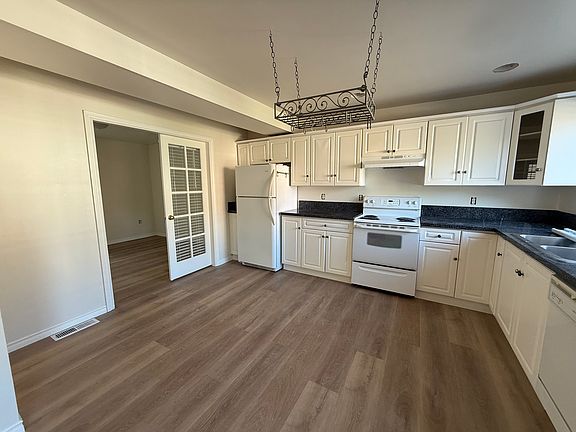 kitchen that is connected to dining room and living room. kitchen connected to double door office.