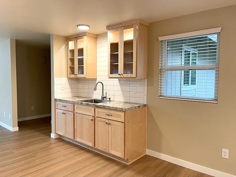 Bar area between kitchen and great room is entertaining heaven! Lighted upper cabinets and tile all around. There's room for your wine cooler too.