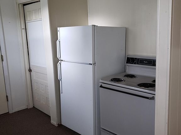 Kitchen showing refrigerator and stove