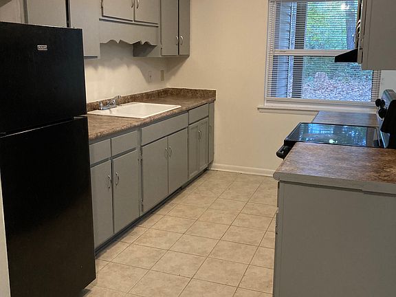 black appliances, tile floors, smooth top stove