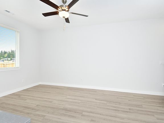 The family room is spacious with a ceiling fan.