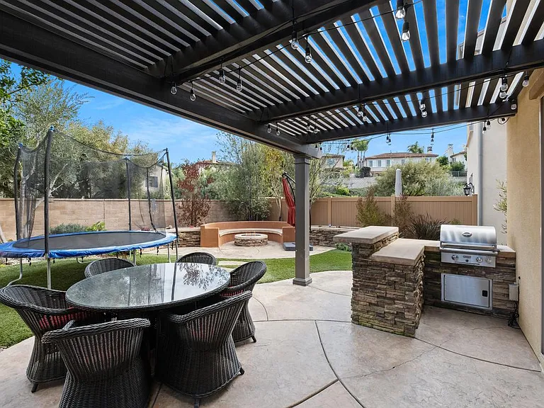 Patio with built in BBQ, fire pit and covered dining area