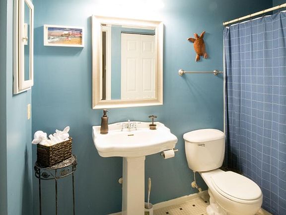 Vibrant bathroom with washer and dryer and multiple sets of