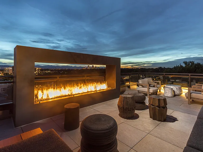 Experience the ultimate cozy retreat with our outdoor rooftop fireplace