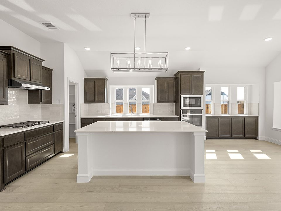Sandstone II floor plan featuring a main-level primary suite, open-concept living, private study, an