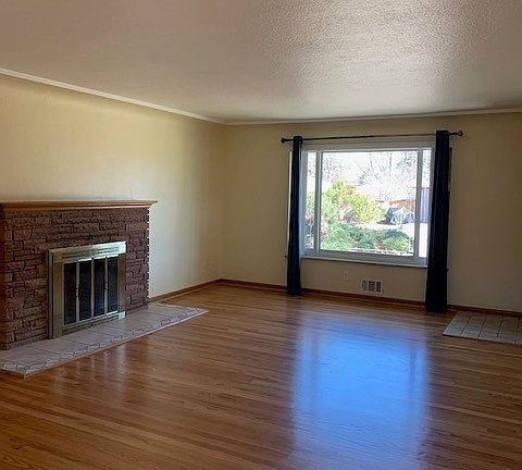 living room with fireplace and wood floors
