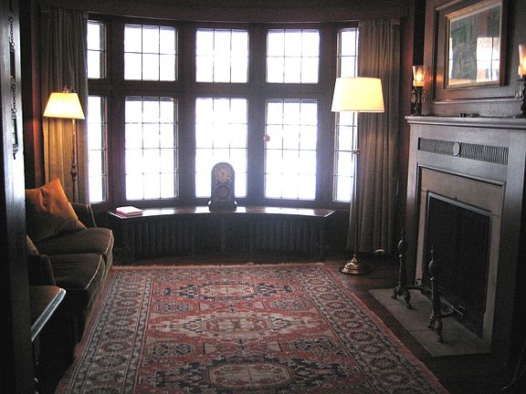 HANDSOME LIBRARY W/CURVED LEADED BAY, STONE FPL, & BUILT-INS