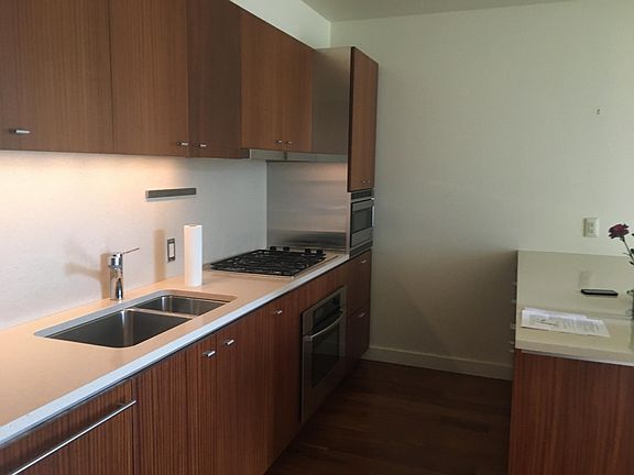 Kitchen includes refrigerator, dishwasher, oven, microwave, stove top
