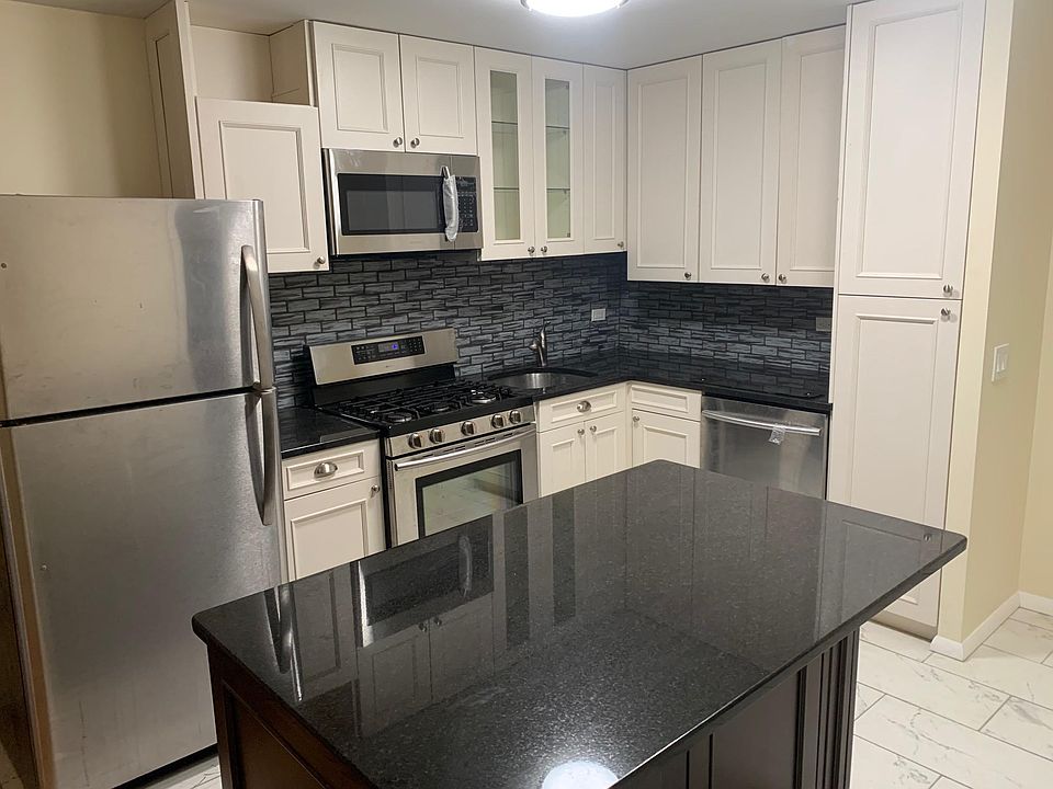 Kitchen with cabinets to ceiling, brand new granite and glass tile