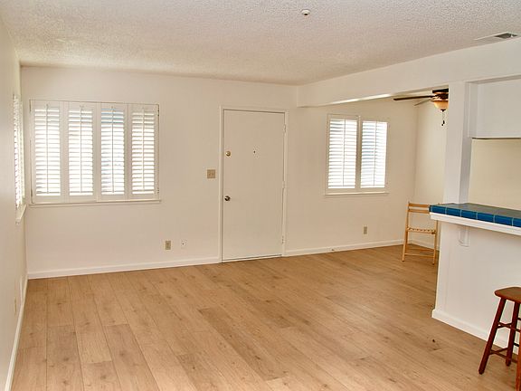 This view shows the living room straight ahead and the dining area to the right, off the kitchen.