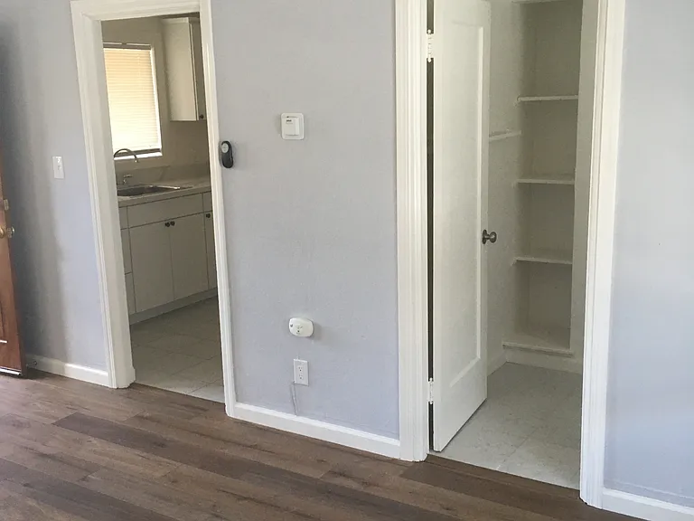 Kitchen and bathroom doors in main room.