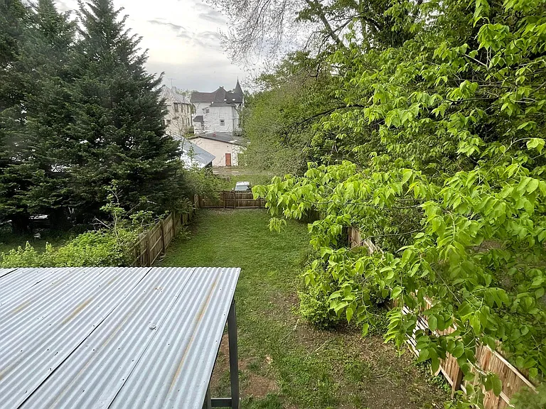 View of Large Fenced In Backyard from Upper Apartment.