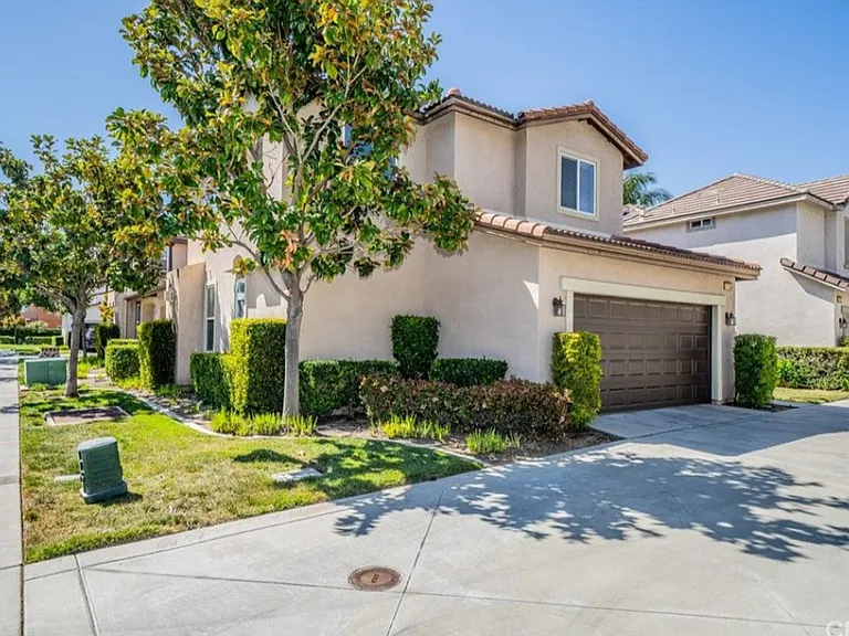 This picture shows the back of the house that includes a spacious 2 car garage. It also shows more of the HOA maintained front yard.