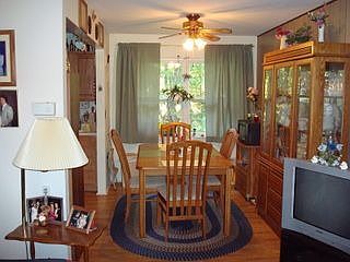 Dining room with wood laminate flooring just off of kitchen and living room