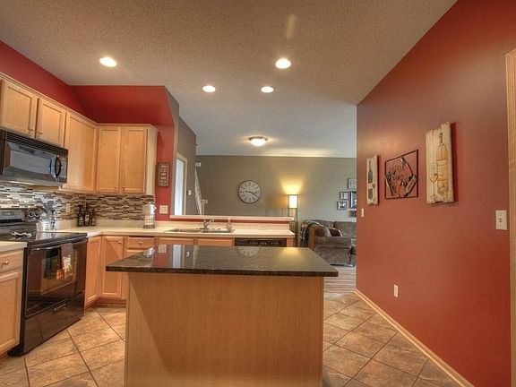 Elegant tiled floors span kitchen and ML 1/2 bathroom.