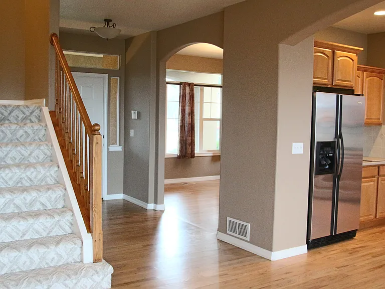 Kitchen on Right, Stairs on left, front door and dining room center