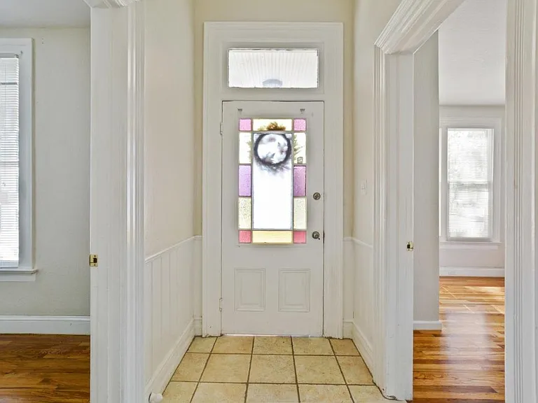 Foyer looking into interior of front door and bedrooms on both sides