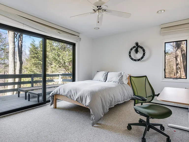 Bedroom on the main floor, with deck and mountain views.