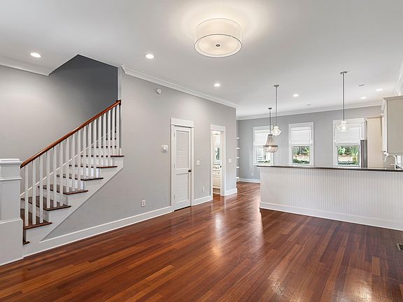 View of living room looking toward kitchen and dining area.
