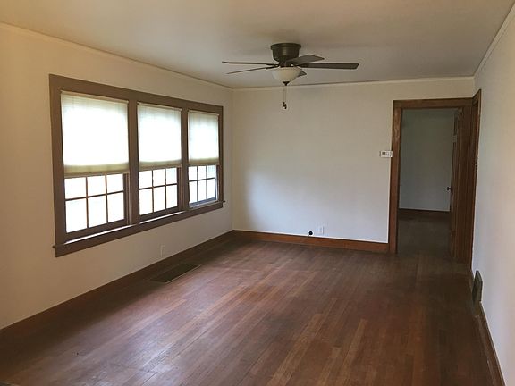 Large living room with hardwood floors and ceiling fan