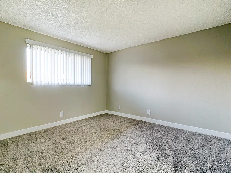Experience tranquility in this airy bedroom, perfect for relaxation and easy organization.