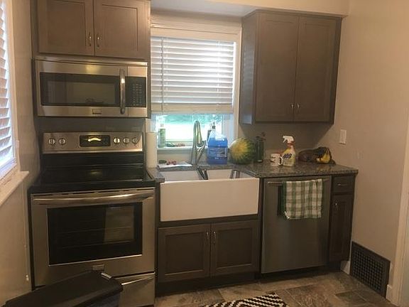 Remodeled kitchen with stainless appliances, farmhouse style