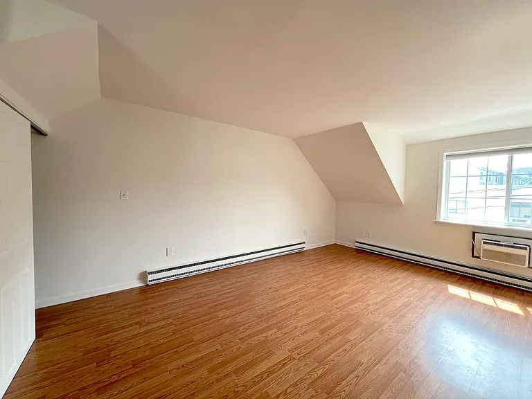 Spacious living room with closet and large windows
