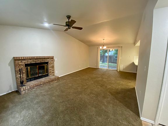 Great room with vaulted ceilings and sliding door to backyard