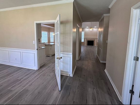 As you enter into a spacious living room to the left and an office/4th bedroom to the right.