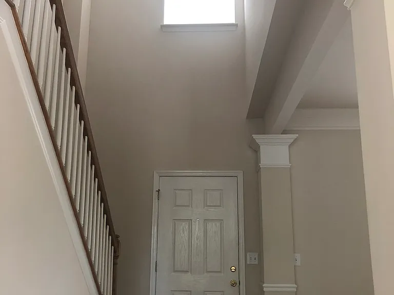 Looking back at beautiful two-story Foyer with source of morning sunlight to illuminate the living spaces in the home on both levels!! Opens to bonus room and office space up.