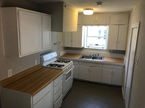 Cute kitchen easily fits a kitchenette table, features a gas stove, spot for countertop dishwasher and opens to your private patio!