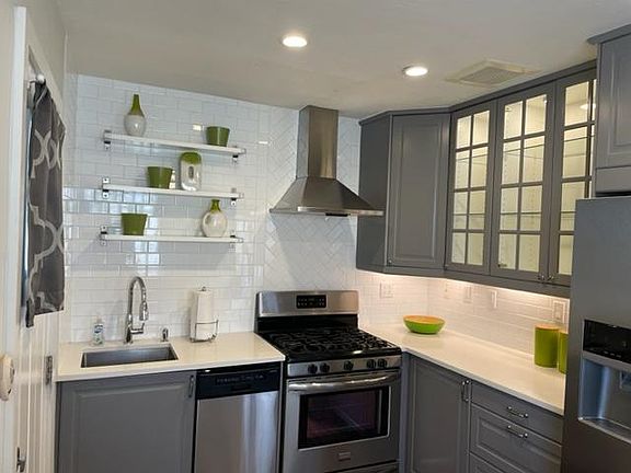Ample Cabinet space with all pots/pans, dishware and flatware.