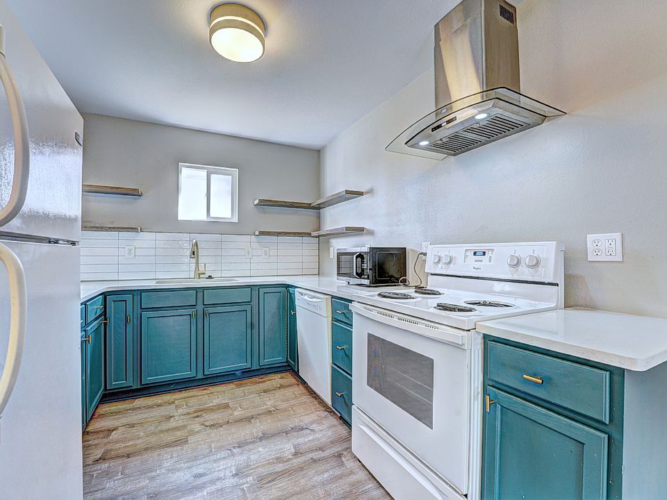 Kitchen - (the following are all new) quartz countertops with large undermount sink, new hood above stove, ceiling lighting, flooring, backsplash, floating shelves, cabinet color with gold/black accents