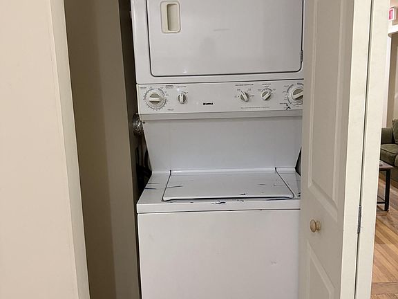 Dedicated laundry closet with a stacked washer and dryer for convenient in-home laundry and easy access off the main living a