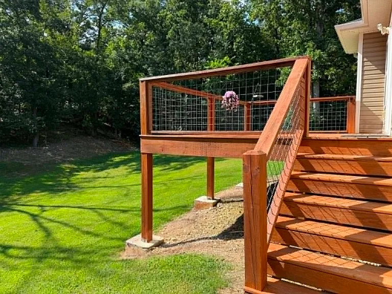 Backyard with newly stained deck and freshly maintained lawn